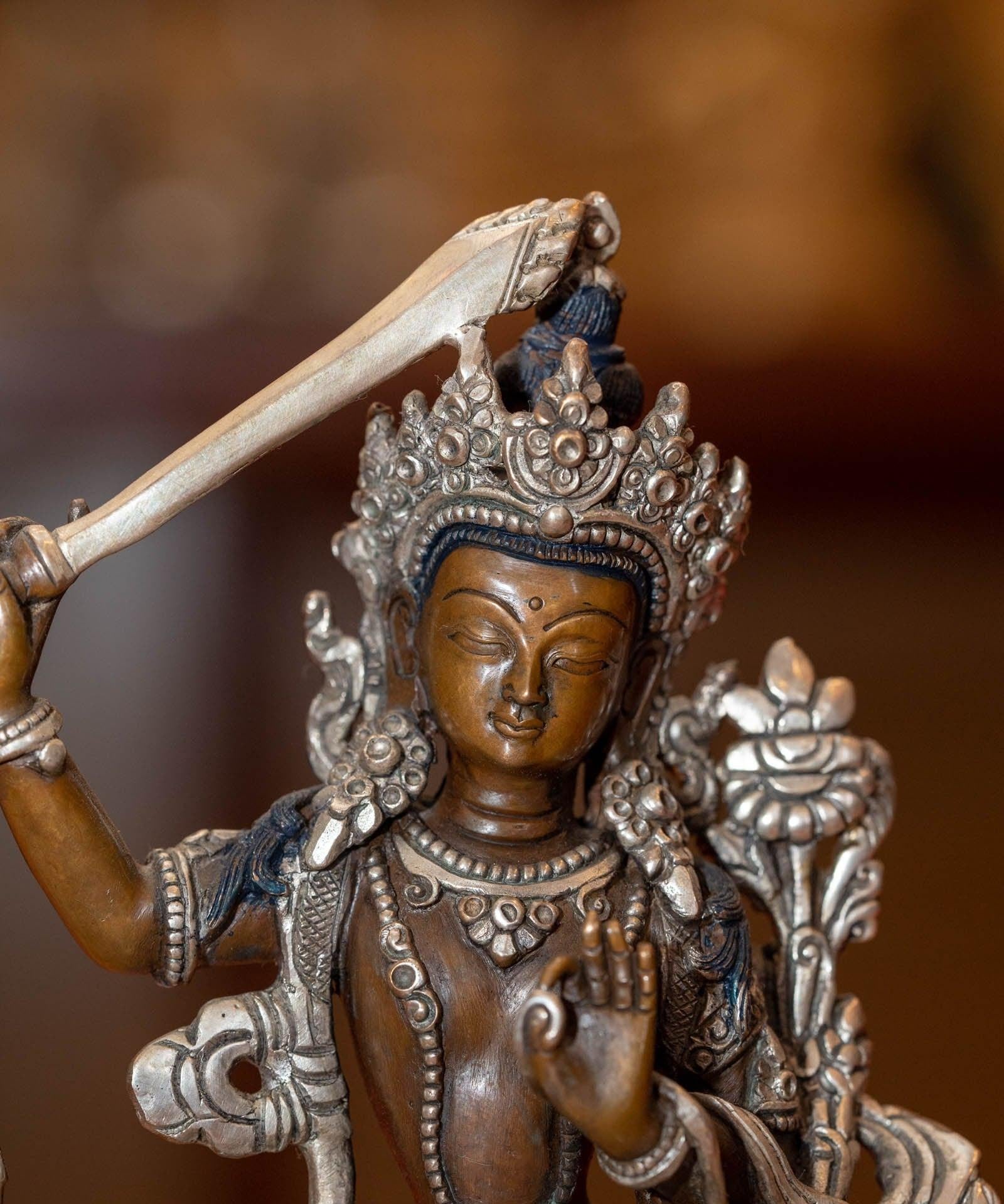  Small copper gilt statue of Manjushri  with silver plated
